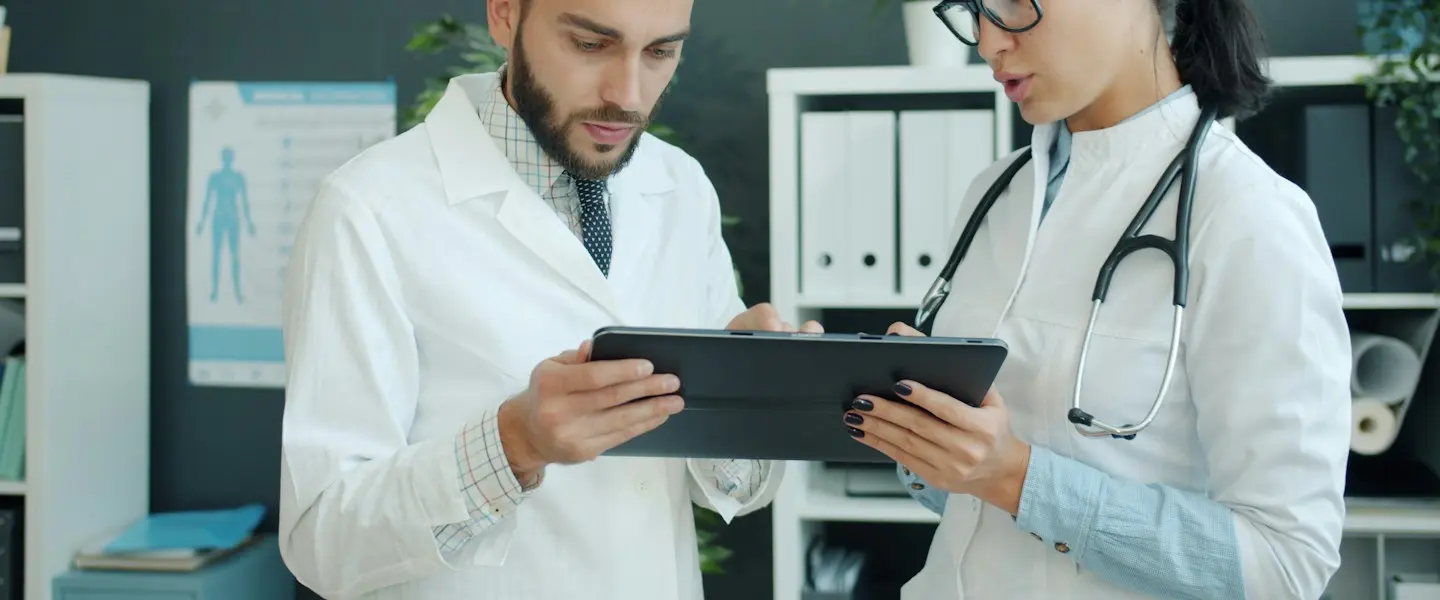 Two clinicians looking at a tablet together